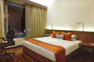 A bed or beds in a room at Vivanta Kolkata EM Bypass