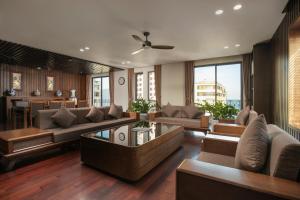 a living room with a couch and a table at Palazzo Boutique Hotel in Da Nang