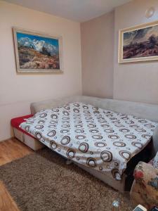 a bed sitting in a corner of a room at Apartment Vuk in Podgorica