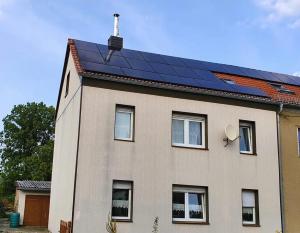 a house with solar panels on top of it at Haus in der Nähe vom See in Markranstädt