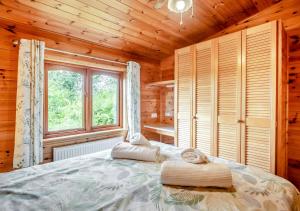 a bedroom with a large bed with a window at Search Light Meadow in Burgh
