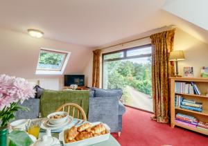 a living room with a table with a plate of food at Vale View in Hollesley