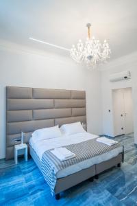 Correnti Boutique Luxury Rooms tesisinde bir odada yatak veya yataklar