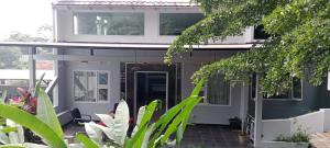 una casa con un porche delantero con plantas en Villa Ambu, en Bandung