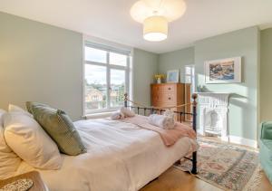 a bedroom with a bed with two stuffed animals on it at Seascape Cottage in Reydon