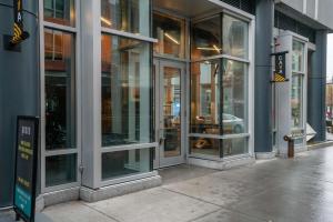 a store front with glass doors on a city street at Calming Kendall Sq Studio w Gym nr MIT BOS-42 in Cambridge
