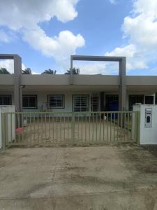 a house with a gate in front of it at AA HOMESTAY TAWAU in Kampong Parit