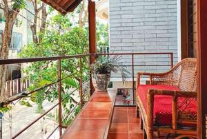 a porch with two chairs and a table on a balcony at Jugglers Rest - Villa in Bangalore