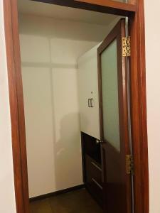 an open door to a room with a closet at Jugglers Rest - Villa in Bangalore