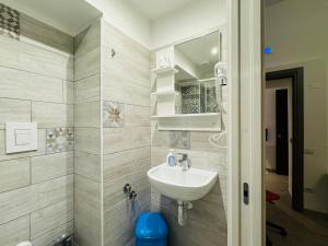 a bathroom with a sink and a mirror at Hostel Mancini Naples in Naples +51 photos