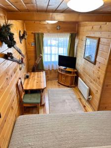 une chambre avec une table et une télévision dans une cabine dans l'établissement Alpine ski chalet Borovets with sauna, à Borovets