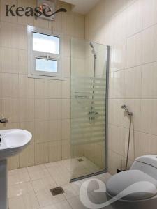 a bathroom with a shower and a toilet and a sink at Kease Al-Mutamarat A-14 Timeless History AG50 in Riyadh