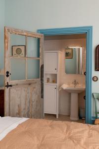a bathroom with a bed and a sink and a door at Domaine de Montclair in Pommiers