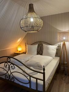 a bedroom with a bed with a chandelier at Ferienwohnung Gipfelglück 50b für Familien in Hamburg