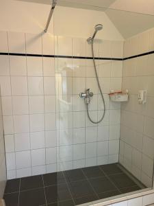 a shower with a glass door in a bathroom at Ferienwohnung Gipfelglück 50b für Familien in Hamburg