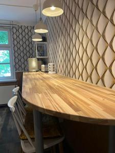 einen Holztisch in einer Küche mit einer Theke in der Unterkunft Studio-Apartment Rektor Suite 26 am Saseler Markt renoviert in Hamburg