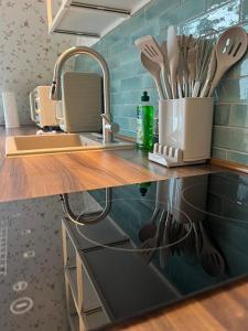 a kitchen counter with a sink and utensils at Studio-Apartment 29 beim Saseler Markt frisch renoviert in Hamburg