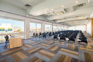 a large room with chairs and tables and windows at AP Eva Senses in Faro +37 photos