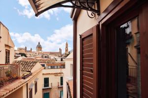 a view of the city from an open window at Happie Casa La Cattedrale in Palermo