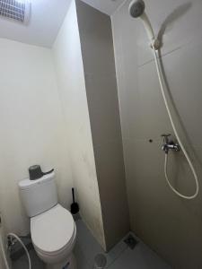 a bathroom with a toilet and a shower at Ita Room Apartement Serpong Green View in Ciater-hilir