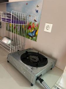 a bird cage with a fan in the corner of a room at Ita Room Apartement Serpong Green View in Ciater-hilir