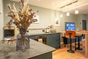 a kitchen with a vase of flowers on a counter at Tryfan - Snowdonia, North Wales in Bethesda