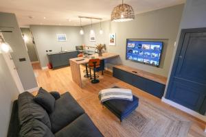 a living room with a couch and a table and a tv at Tryfan - Snowdonia, North Wales in Bethesda