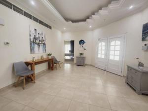 a large white room with a table and chairs at Villa Room #1 Near Burj Al A-rab Beach in Dubai