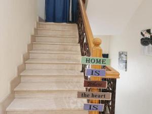 a stairway with signs that say home is where the heart is at Villa Room #1 Near Burj Al A-rab Beach in Dubai