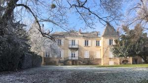 a large brick house with a driveway in front of it at Domaine de Montclair in Pommiers
