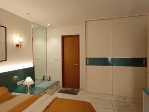 a bedroom with a bed and a large mirror at Gangothrii in Trivandrum