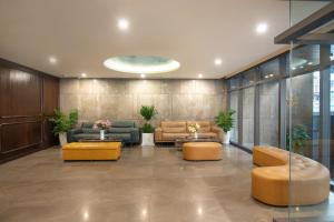 a lobby with couches and tables in a building at Palazzo Boutique Hotel in Danang