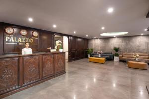 a lobby of a hotel with a woman standing in the lobby at Palazzo Boutique Hotel in Danang