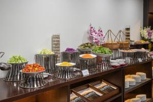 a buffet line with bowls of food on display at Palazzo Boutique Hotel in Danang