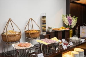 a buffet with baskets of food on a table at Palazzo Boutique Hotel in Danang