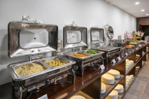 a buffet line with several trays of food at Palazzo Boutique Hotel in Danang