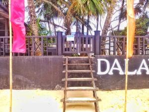 a ladder in the sand next to a sign at DALAWELLA BEACH RESORT in Unawatuna