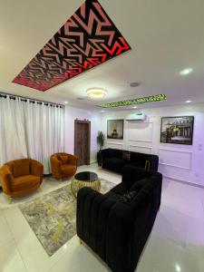 a living room with couches and chairs at SAMBEST Home in Lagos