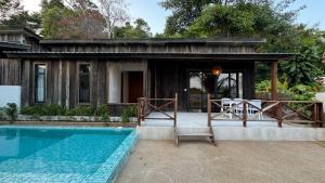 a house with a swimming pool in front of a house at One Beach Private Villa in Phumĭ Kaôh Rŭng Sâmlœ̆m Khnŏng