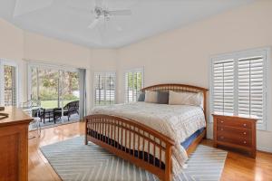a bedroom with a bed in a room with windows at Sunrise Oaks in Port Orange