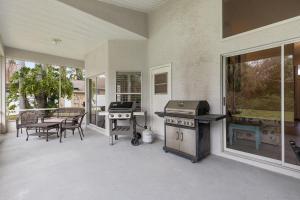 a patio with a grill and a table and chairs at Sunrise Oaks in Port Orange
