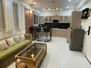 a living room with a couch and a kitchen at Reeta Niwas Solan in Barog