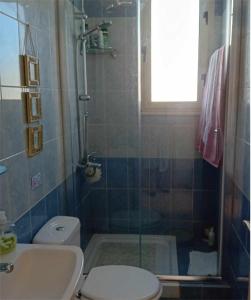 a bathroom with a shower and a toilet and a sink at Sunset Boutique Guest House in Paphos City