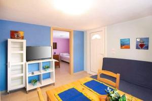 a living room with a couch and a table at Vaso apartment Limenaria Thasos in Limenaria