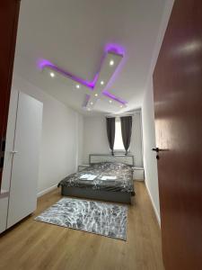 a bedroom with a bed with a x on the ceiling at 38 Apartment 2 in Pristina