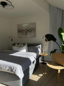 a bedroom with two beds and a potted plant at FEWO Studio7 in Vorderelsenwang