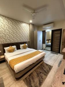a bedroom with a large bed in a room at Hotel The Heera Divine in Kānpur