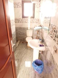 a bathroom with a sink and a toilet at JUMERA HOUSE CRISS RESORT NAAMA Bay in Sharm El Sheikh +16 photos