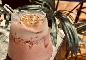 a drink with a slice of orange in a glass at Ahdu Backpacker Inn B&B in Lanyu