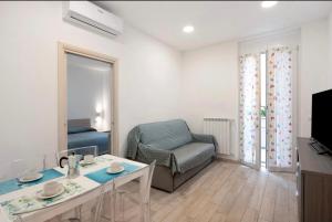 a living room with a couch and a chair and a table at Casavienna app A2 in Varazze